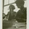 At the table.
