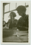 At the table.