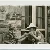 Rosika Schwimmer; Margaret Sanger.  Lighting cigarettes.