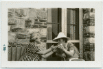 Rosika Schwimmer; Margaret Sanger.  Lighting cigarettes.