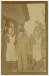 Three women standing in front of a building.