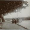 Two women near a boat on a canal, [Boat operator?]