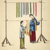 Two women hanging dyed skeins on wood and bamboo racks