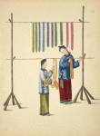 Two women hanging dyed skeins on wood and bamboo racks
