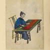 Woman seated at a table, cutting cloth