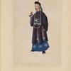 Man wearing long beaded necklace and tunic with design of large white bird