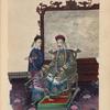 Man sitting on ornately carved chair in front of screen ; young attendant next to chair.