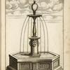 Fountain in hexagonal basin with multiple spouts from small basin on top; central column decorated with lion's heads.