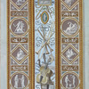 Central decoration contains images of musical instruments; lower panel contains scene of sea goddess and child