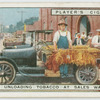 Farmer unloading tobacco at sales warehouse.