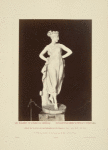 Statue of woman wearing crown of flowers and gown.