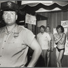 Policeman and bar patrons in front of Christopher's End bar