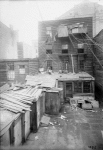 Tenement Backyard with many wires and outhouses