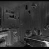 Kitchen with stove, sink and utensils.