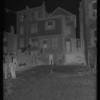 Tenement backyard with laundry & two men in suits