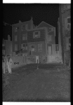 Tenement backyard with laundry & two men in suits