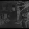 Tenement backyard with several women and children