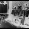 Inhabited parlor with sewing machine and cluttered shelf