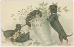 Dogs playing with vase of mistletoe and holly.