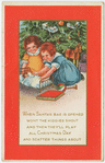 Girls playing by Christmas tree