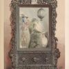 A Chinese looking glass in carved wood frame.