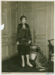 French woman by door.