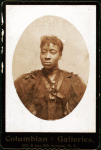 Woman wearing dress covered with lace across the bodice