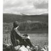 Woman overlooking a mountain scene, reverse