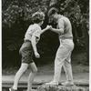 Two women crossing a creek