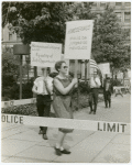 Barbara Gittings picketing behind a police barrier