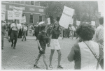 Women picketing while holding hands, original