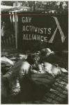 Men kissing under the Gay Activists Alliance banner