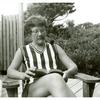 Barbara Gittings reading while smoking a pipe
