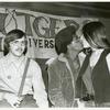 Man and kissing women in front of Rutgers banner