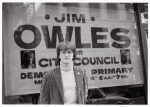 Jim Owles in front of campaign banner