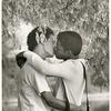 Men kissing under tree