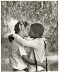 Men kissing under tree