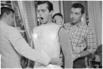 Robert Goulet (center) being costumed for the stage production Camelot