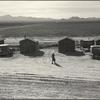 6A. She picks in these broad fields of cotton (seen across the road) and lives in one these cabins