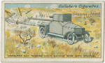 Armoured car tearing down barbed wire with grapnel.