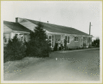 Family standing in front of home