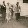 Wedding couple Stanley Joseph George and Josephine Mitchell walk with Reverend P.C. Blackburn