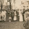 Wedding party with boy in foreground