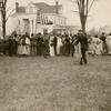 Gypsy wedding, Suffolk, Virginia. Wedding guests on lawn with man holding American flag