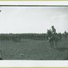 Man mounted on horse in front of a group of soldiers, Camp Black, Long Island, New York