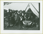 Group gathered around a man playing the dulcimer at Camp Black, Long Island, New York