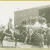 Men loading items into train car at Camp Black, Long Island, New York