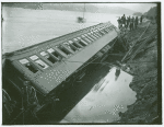 Overturned train car with broken windows