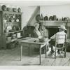 Woman and man sit in Walt Whitman farmhouse kitchen