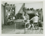 Woman and man sit in Walt Whitman farmhouse kitchen